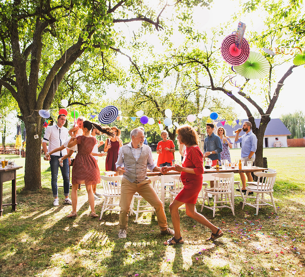 A vibrant scene of friends having fun at an outdoor party, showcasing smiles and a festive atmosphere.