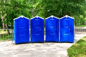 A portable toilet creates an eyesore at an event because of incorrect placement